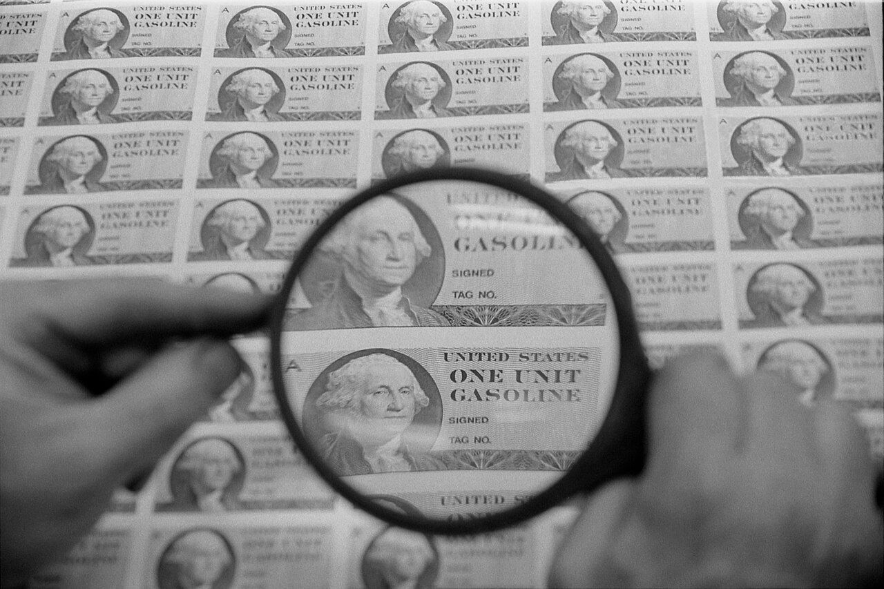 A magnifying glass held over a printed page, enlarging a block of text beneath it.