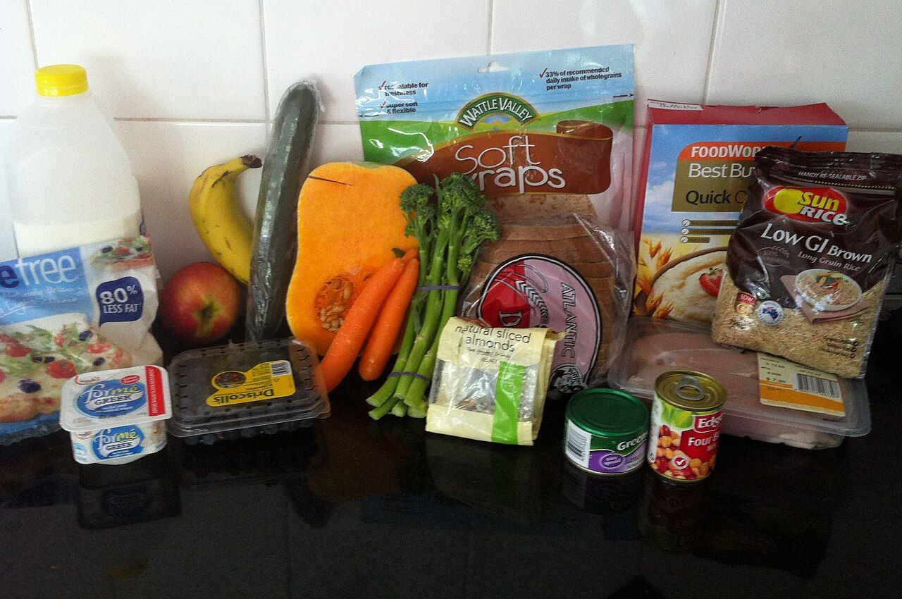 A spread of whole foods including vegetables, fruit, grains, and protein foods