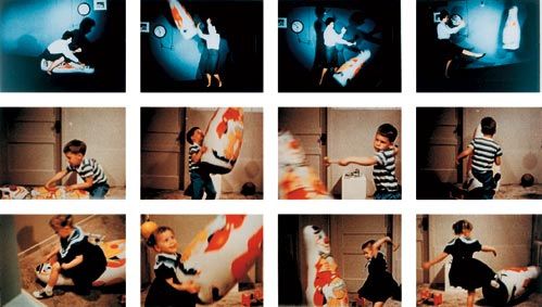 A child imitating an adult striking an inflatable Bobo doll
