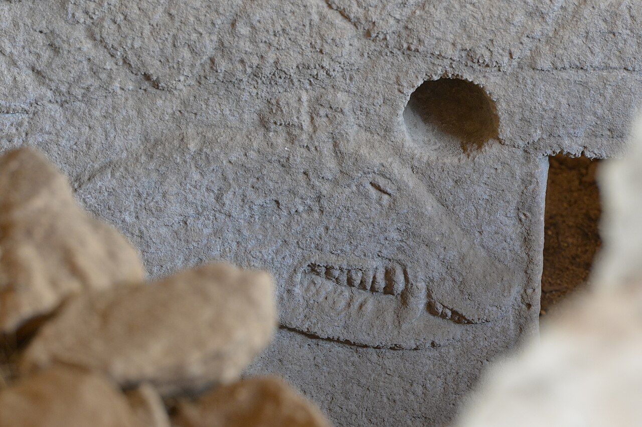 Carved T-shaped limestone pillars standing in a circular stone enclosure at Gobekli Tepe in southeastern Turkey, with relief carvings of animals visible on the pillar faces