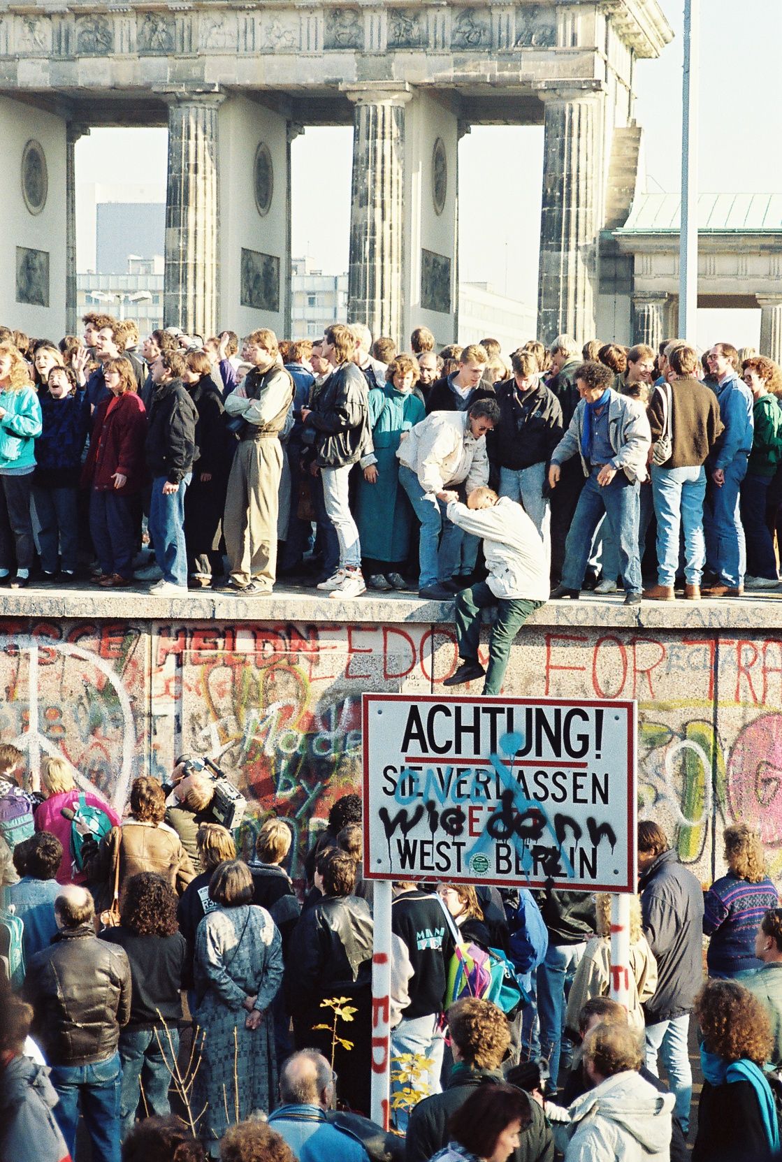 Berliners on the Wall at the Brandenburg Gate in November 1989 &mdash; a border that had killed people for twenty-eight years opened in a single evening of confusion.